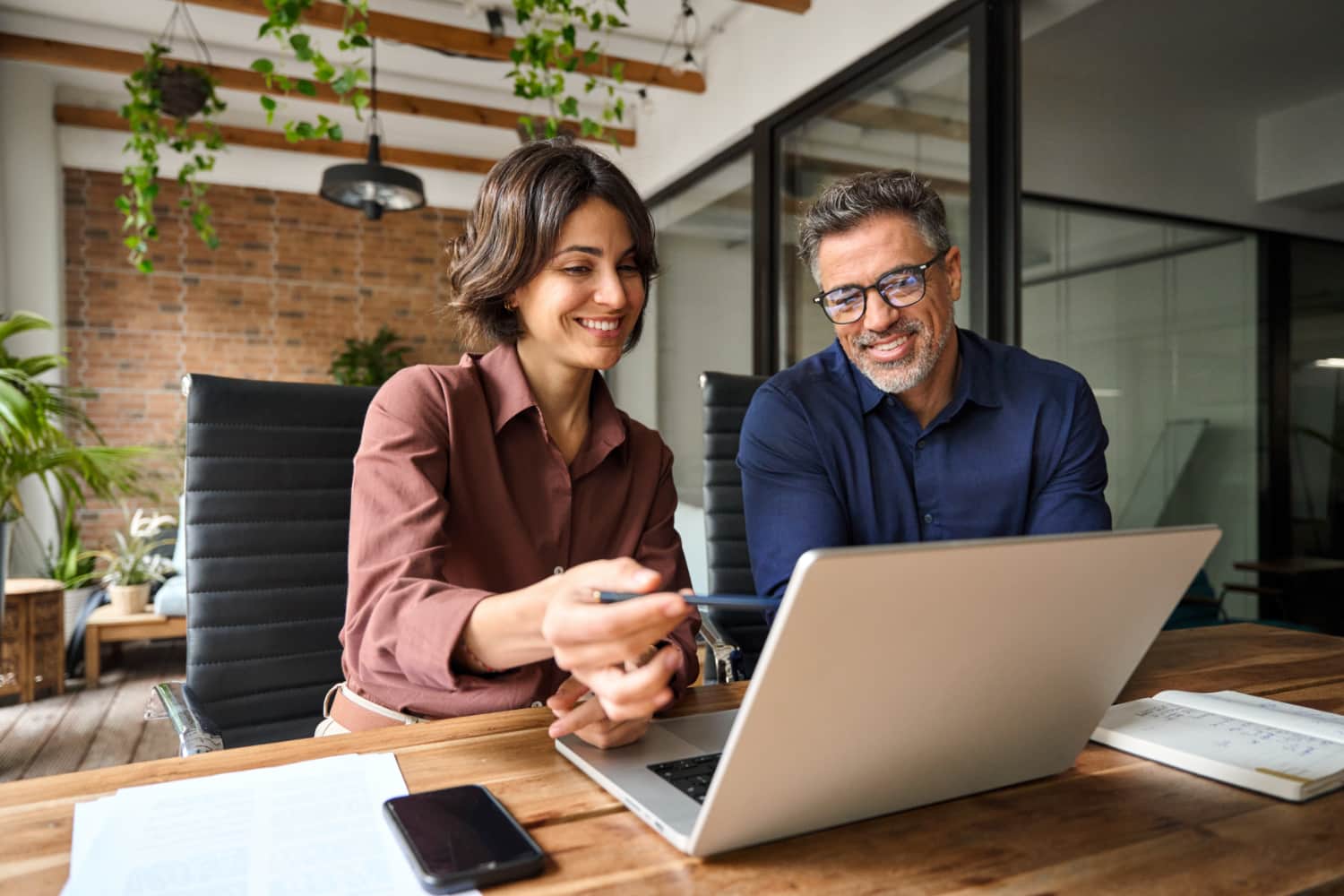 man and woman looking at computer at work