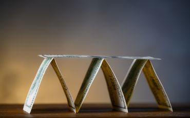 base of pyramid with dollar bills