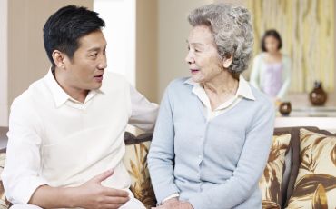 Man talking to elderly mother