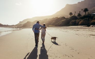 Older couple walking on beach