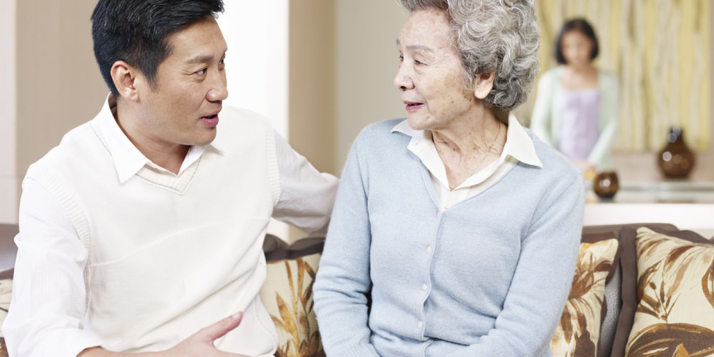 Man talking to elderly mother